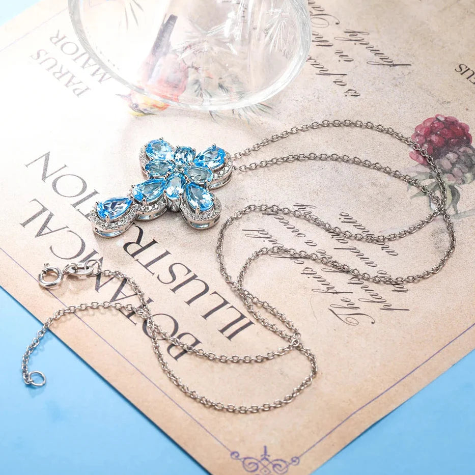 Pear-cut Swiss Blue Halo Cross Necklace